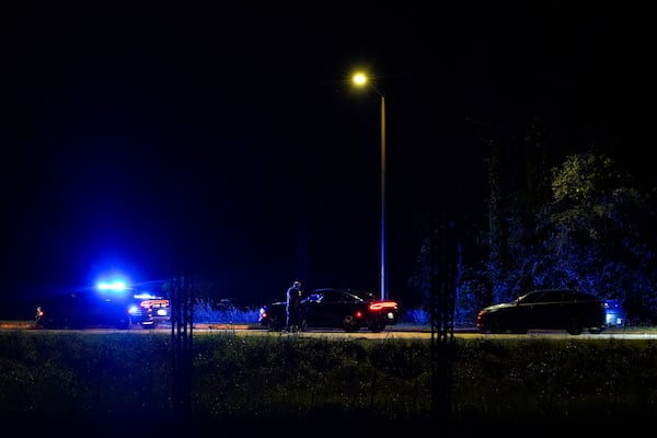 Atlanta police officers are seen on Benjamin E. Mays Drive after a shooting early Sunday.