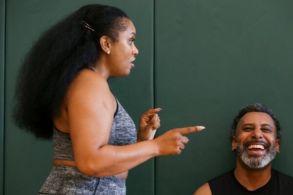 Kaye Jackson tells a story while her husband Tiran Jackson laughs while sitting on the benches of the basketball court at Life Time Woodstock on Wednesday, July 6, 2022, in Woodstock, Georgia. (Chris Day/Christopher.Day@ajc.com)