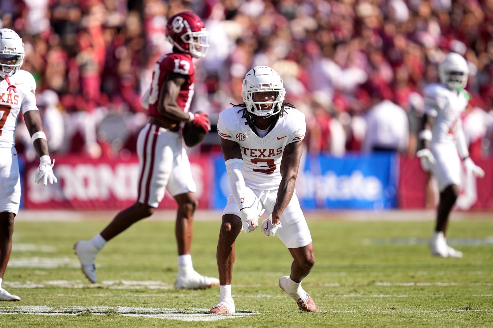 Texas defensive back Jaylon Guilbeau (3) celebrates after stopping Oklahoma wide receiver J.J. Hester (13) after a catch in the first half of an NCAA college football game in Dallas, Saturday, Oct. 12, 2024. (AP Photo/Tony Gutierrez)