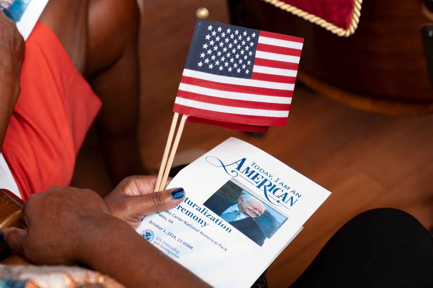 A person holds the program for a Naturalization ceremony at Jimmy Carter National Historic Park in Plains on Tuesday, Oct. 1, 2024. The ceremony was held in honor of President Carter’s 100th birthday.  Ben Gray for the Atlanta Journal-Constitution