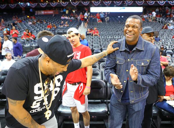 The Dream (left) and Chris Rock share a laugh court side as the Hawks prepare to play the Wizards in their Eastern Conference Semifinals game 5 on May 13. AJC photo: Curtis Compton / ccompton@ajc.com