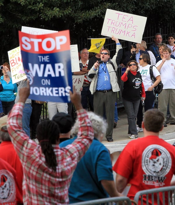 Georgia Tea Party Patriots, background, attempt to counter local unions’ supporters in dueling labor rallies at the Georgia Capitol in Atlanta. Curtis Compton / AJC 2011 file photo