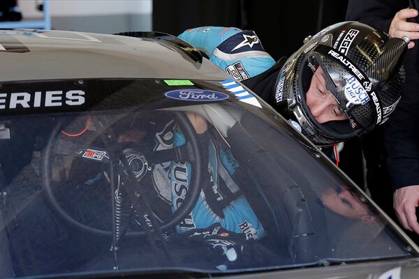 Kevin Harvick climbs into his car to run   practice laps Saturday, Feb. 8, 2020 at Daytona International Speedway in Daytona Beach, Fla. (Terry Renna/AP)