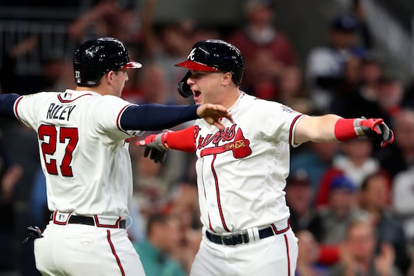 Braves rightfielder Joc Pederson celebrates hitting a two-run home run with teammate Austin Riley (27)  during the fourth inning of Game 2 of the NLCS Sunday, Oct. 17, 2021, against the Los Angeles Dodgers at Truist Park in Atlanta. (Curtis Compton / curtis.compton@ajc.com)