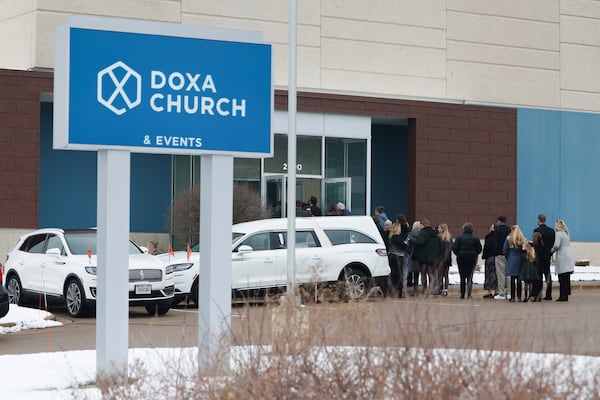 People line up outside DOXA Church for Erin Michelle West's funeral on Monday, Dec. 23, 2024, in Fitchburg, Wis. (Owen Ziliak/Wisconsin State Journal via AP)