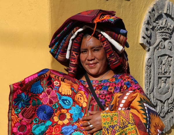 A street vendor displays some of the colorful embroidered fabrics in Antigua. (Doug Hansen/San Diego Union-Tribune/TNS)