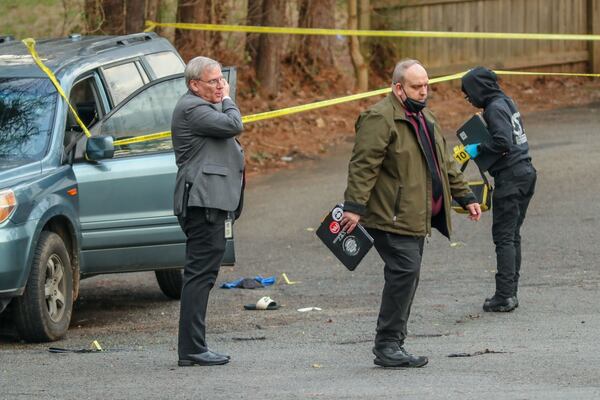 DeKalb County investigators gather evidence after a man was shot and killed at an apartment complex Tuesday morning.