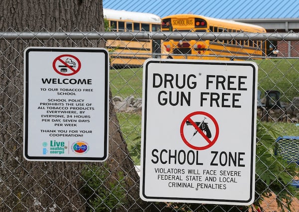 Signs hang on the fence around the Taliaferro County school complex on Wednesday, May 23, 2018, in Crawfordville. Taliaferro County is the state’s smallest school district. Curtis Compton/ccompton@ajc.com