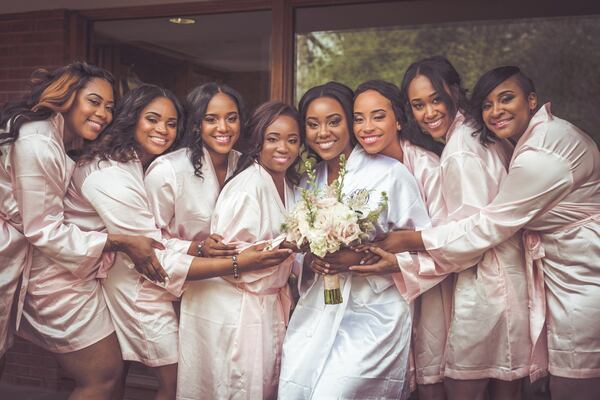 Asha Staples (pictured with bouquet), her maid of honor Jamila Staples (immediately left of Asha) and her six bridesmaids. CONTRIBUTED BY LANE COSTA FOTOGRAFIAS