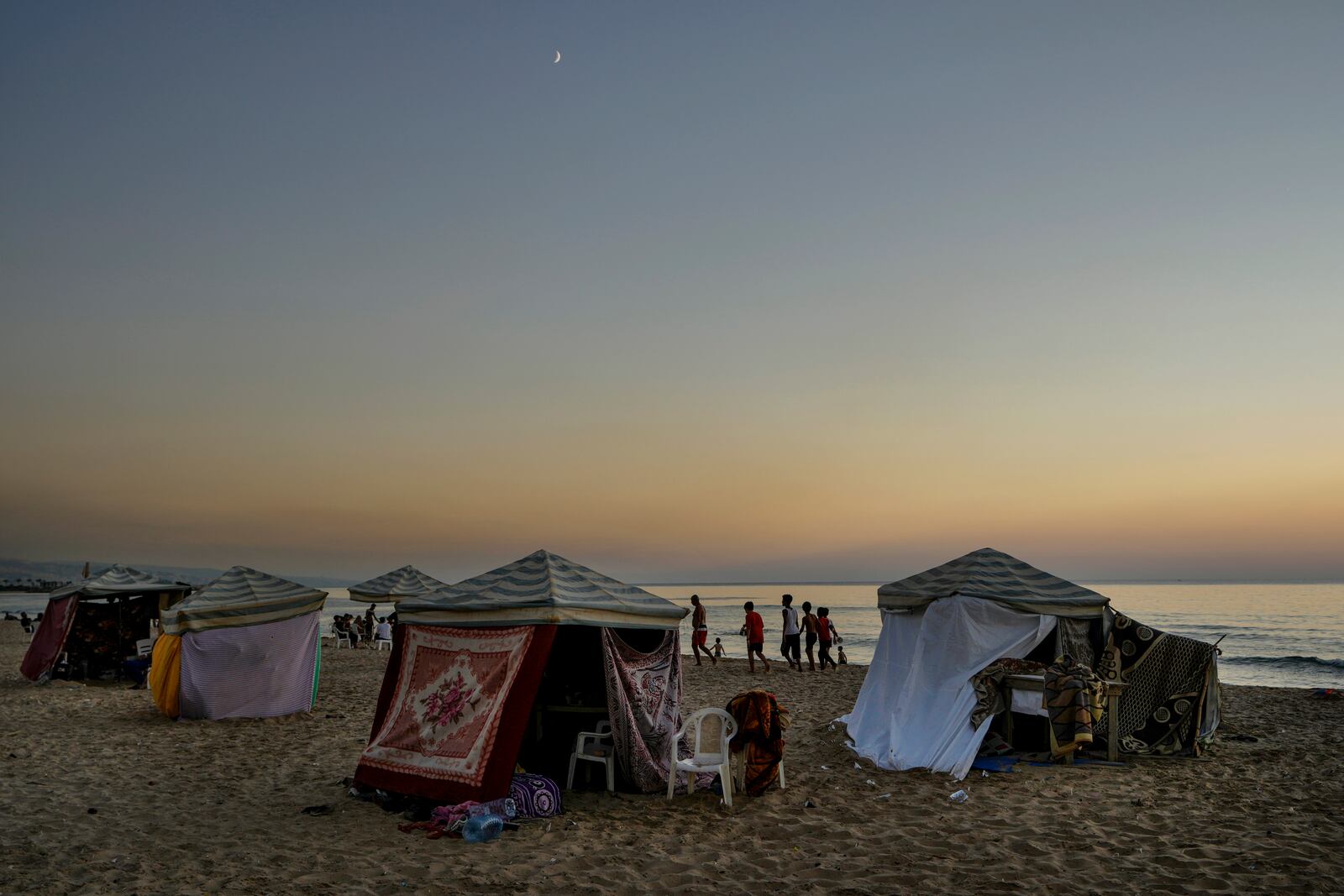 Tents set up as temporary shelters by displaced families fleeing the Israeli airstrikes in the south and Dahiyeh, are seen along the Ramlet al-Baida public beach in Beirut, Lebanon, Tuesday Oct. 8, 2024. (AP Photo/Bilal Hussein)