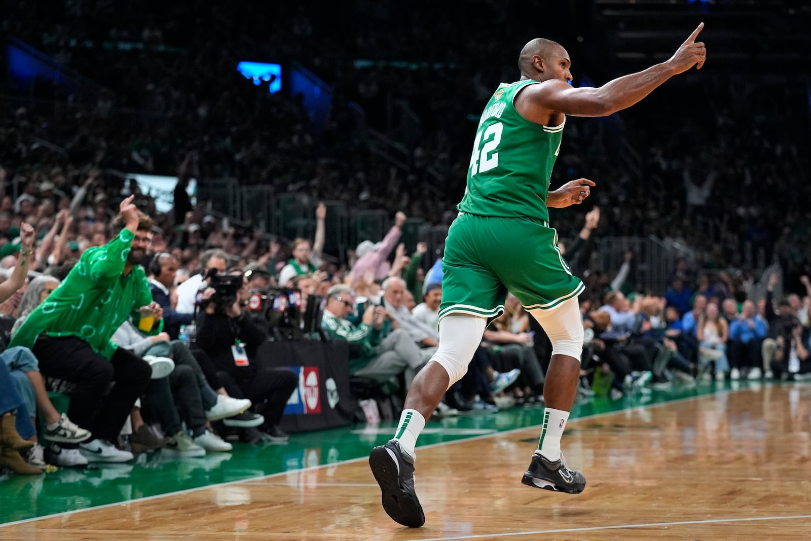 Boston Celtics center Al Horford (42) celebrates after a 3-pointer during the second half of an NBA basketball game against the New York Knicks, Tuesday, Oct. 22, 2024, in Boston. (AP Photo/Charles Krupa)