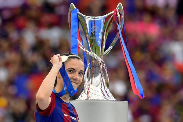 FILE - Barcelona's Aitana Bonmati holding up her medal walks past the trophy after winning the women's Champions League final soccer match between FC Barcelona and Olympique Lyonnais at the San Mames stadium in Bilbao, Spain, Saturday, May 25, 2024. (AP Photo/Alvaro Barrientos, FIle)