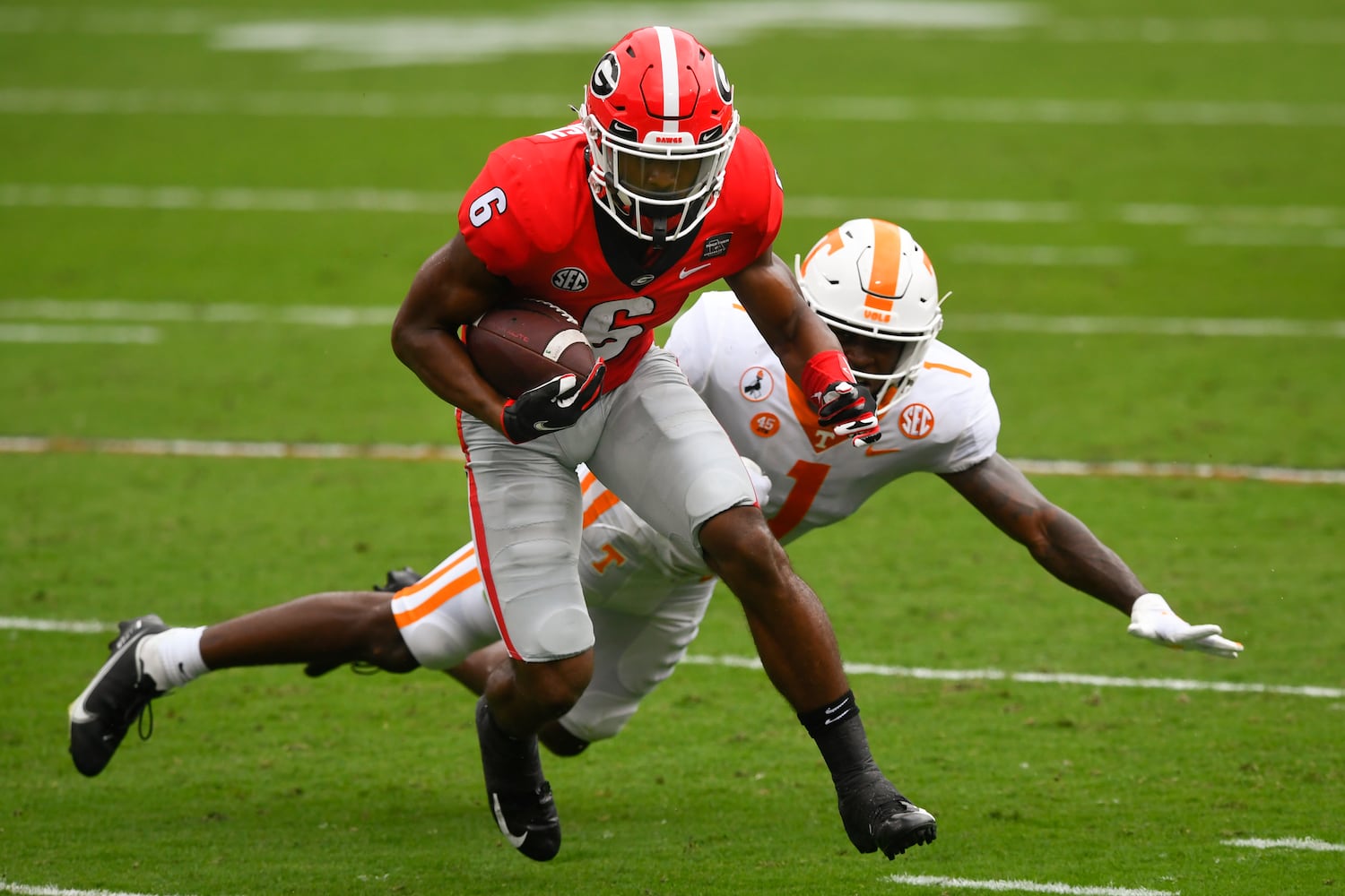 Georgia running back Kenny McIntosh (6) avoids the tackle of Tennessee defensive back Trevon Flowers during the second half of a football game Saturday, Oct. 10, 2020, at Sanford Stadium in Athens. Georgia won 44-21. JOHN AMIS FOR THE ATLANTA JOURNAL- CONSTITUTION