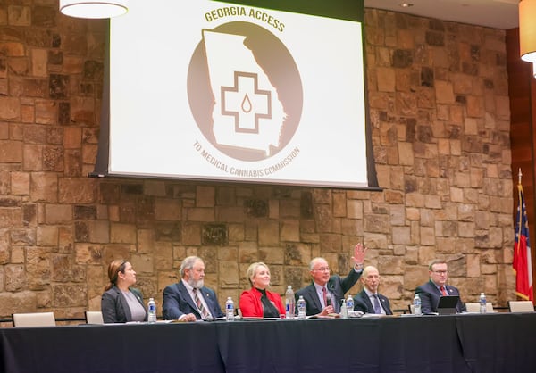 The Georgia Access to Medical Cannabis Commission Chair Sidney Johnson, center with hand raised, begins a meeting Wednesday before hearing public comments at the Lanier Technical College Ramsey Conference Center in Gainesville. Jason Getz / Jason.Getz@ajc.com)
