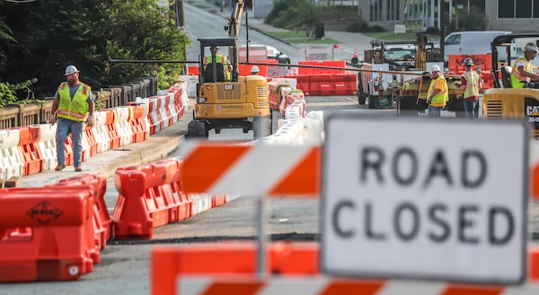 Workers repair a bridge on Cheshire Bridge Road after a fire Aug. 4.
