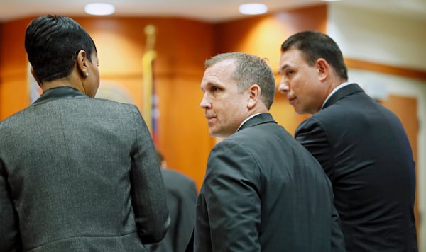 September 20, 2019 - Decatur - Prosecutors Buffy Thomas (from left), Pete Johnson and Lance Cross confer during the hearing.  Judge LaTisha Dear Jackson, the judge overseeing the murder trial against former DeKalb police officer Chip Olsen holds a pretrial hearing to consider the defense's request to keep out evidence that victim Anthony Hill was mentally ill and an Afghan war vet. Bob Andres / robert.andres@ajc.com