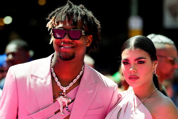 Braves superstar Ronald Acuña Jr. and fiancee Maria Laborde stop for a photo op during their walk down the red carpet prior to Tuesday's MLB All-Star game. (AP Photo/Lindsey Wasson)