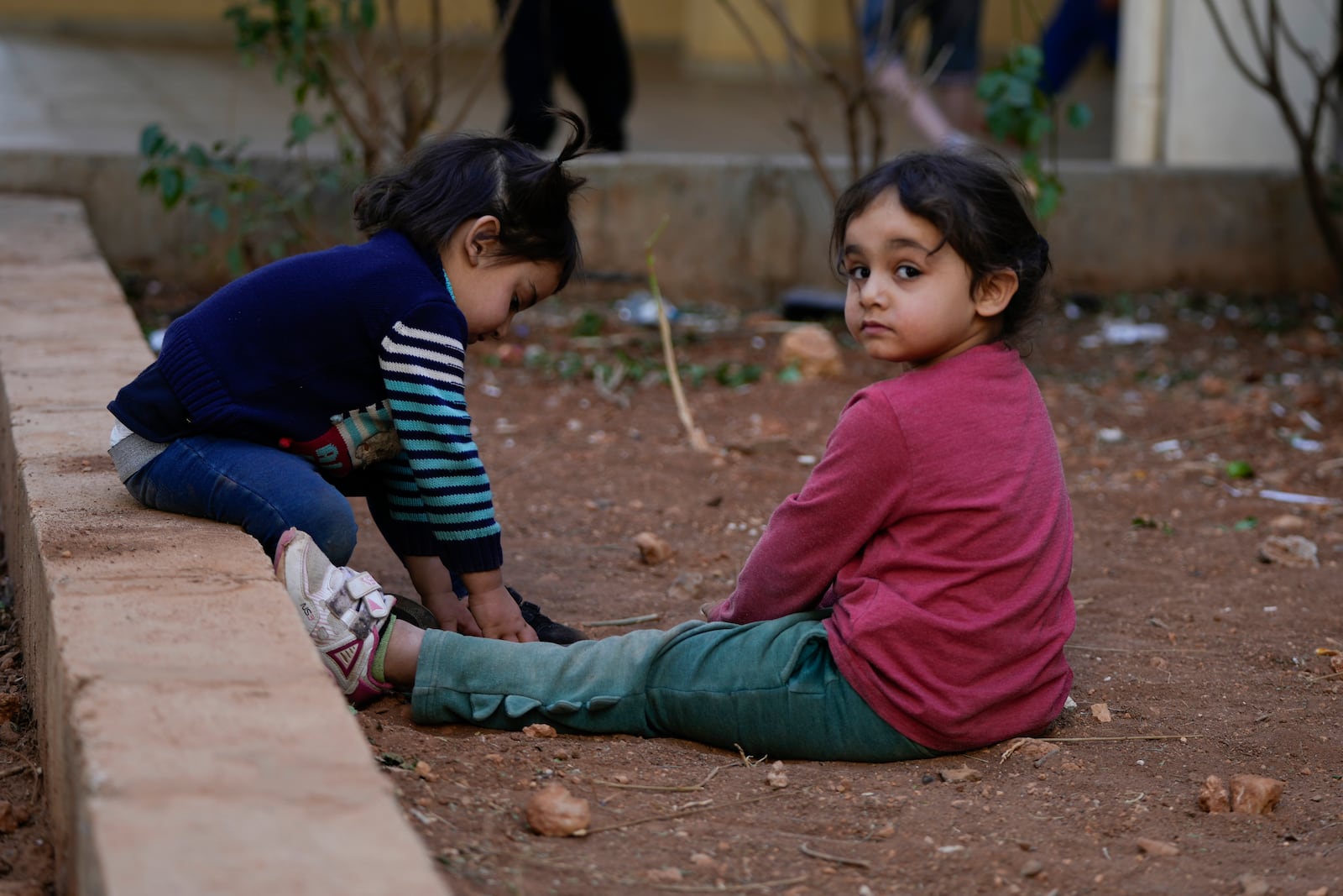 Displaced children, who fled Baalbek city and the nearby towns of Douris and Ain Bourday with their families amid the ongoing Hezbollah-Israel war, play inside a school being used as a shelter, in Deir Al-Ahmar, east Lebanon, Thursday, Oct. 31, 2024. (AP Photo/Hassan Ammar)