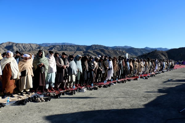 People attend the funeral prayer of Khalil Haqqani, the minister for refugees and repatriation, during his funeral procession in eastern Paktia province, Afghanistan, Thursday, Dec. 12, 2024. (AP Photo/Saifullah Zahir)