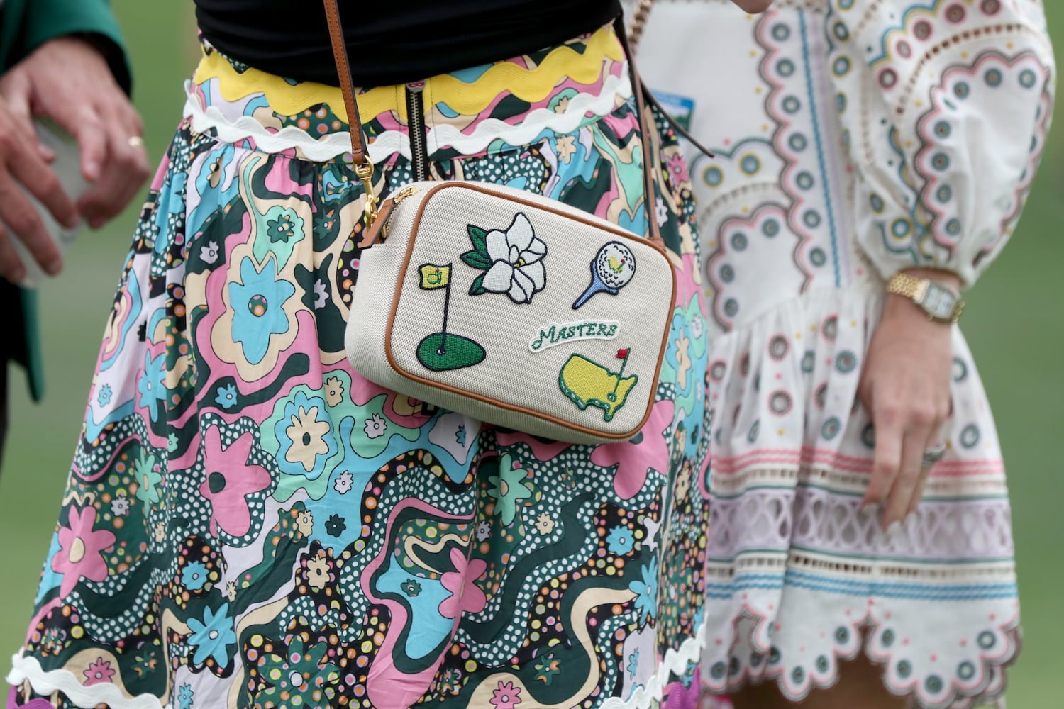 April 10, 2021, Augusta: Patrons wear a Masters branded purse on second hole during the third round of the Masters at Augusta National Golf Club on Saturday, April 10, 2021, in Augusta. Curtis Compton/ccompton@ajc.com