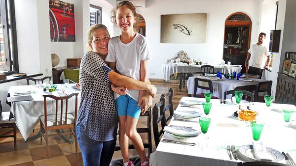 Niuris Higueras Martinez gives her daughter, Ysabella Cabeiro Higueras a big hug, Tuesday, Sept. 26, 2017 inside of their Havana restaurant Atelier. The restaurant suffered some wind damage and minor flooding from the wind and storm surge from Hurricane Irma&apos;s outer bands. Atelier reopened two weeks after the storm. (Emily Michot/Miami Herald/TNS)