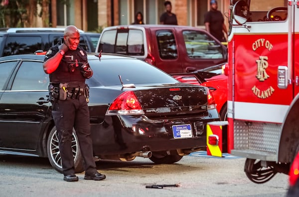 August 15, 2022 Atlanta: Atlanta police work the 2800 MLK Jr. Drive scene at the Seven Courts Apartments where a witness to a fatal stabbing shot a man he says was the suspect after he allegedly lunged at him with a knife.  (John Spink / John.Spink@ajc.com)

