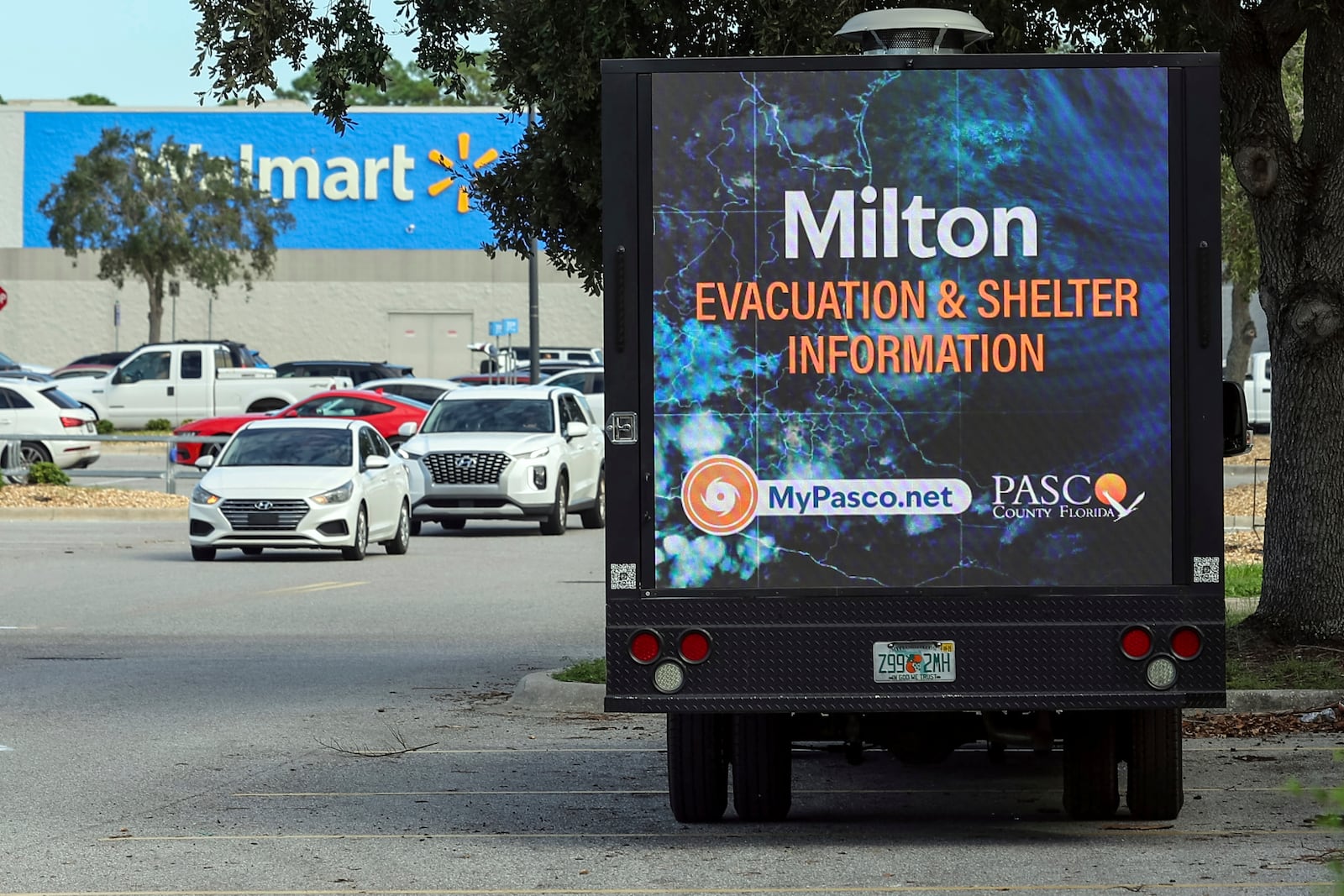 An LED signage truck with loudspeakers makes announcements informing residents of mandatory evacuations in preparation for Hurricane Milton on Tuesday, Oct. 8, 2024, in Port Richey, Fla. (AP Photo/Mike Carlson)