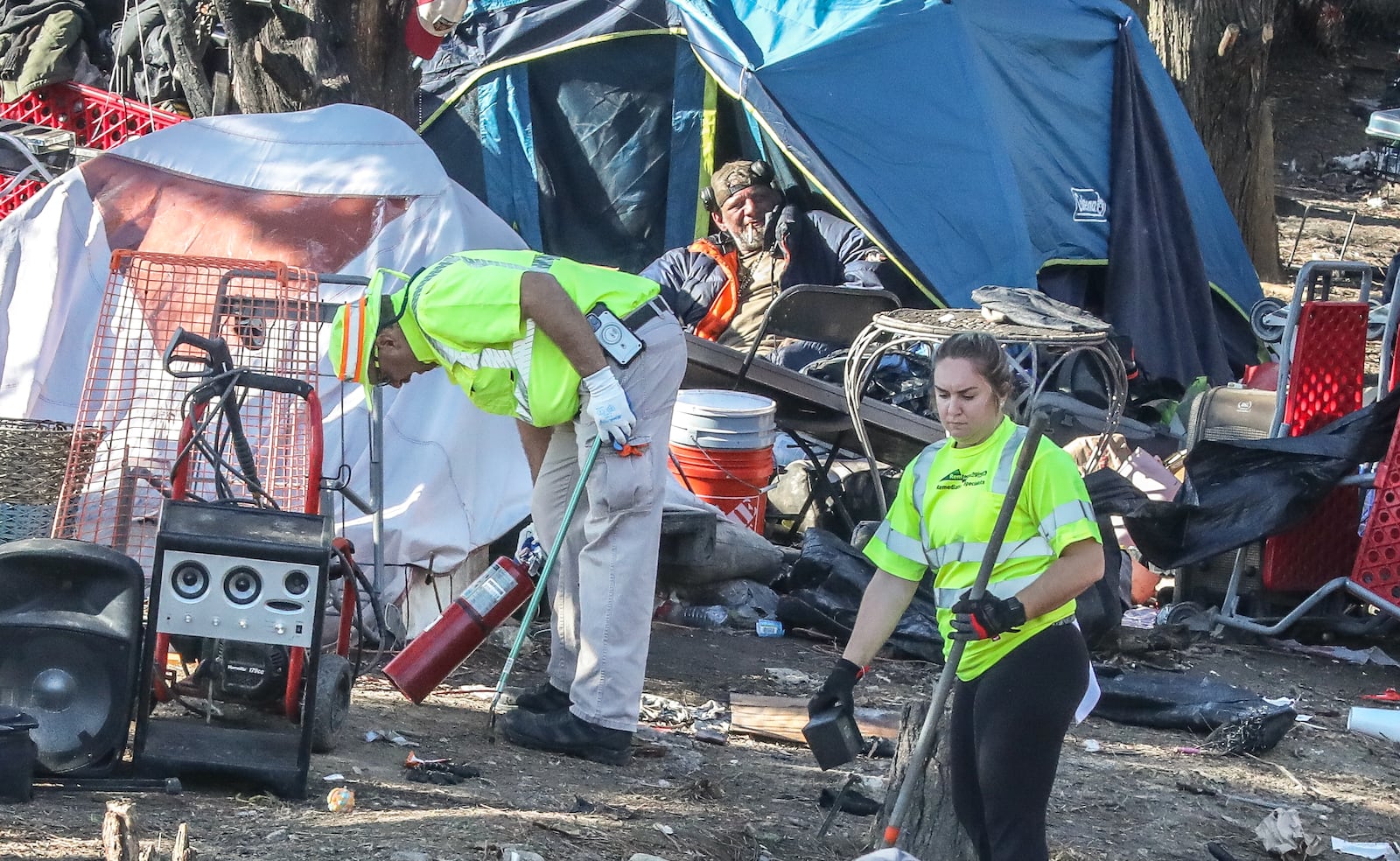 The city of Atlanta has started a major new effort to clear out people living under bridges and encampments. A man watches from his tent as cleanup efforts begin on Monday, Feb. 26, 2024. (John Spink / John.Spink@ajc.com)

