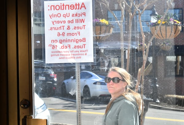 The sign outside the Canton Shoe Repair announces that the shop is not taking new customers but is staying open for pickups only. (Hyosub Shin / Hyosub.Shin@ajc.com)