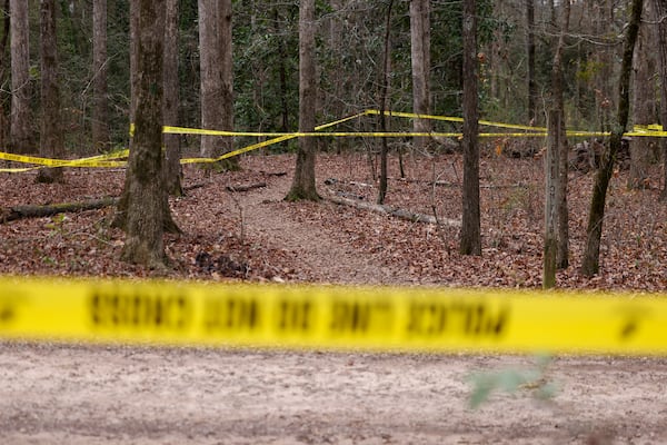 Police tape ropes off the crime scene on a trail behind Lake Herrick in Athens at the University of Georgia on Friday, Feb. 23, 2024. A female nursing student was found dead nearby on Thursday. (Jason Getz / jason.getz@ajc.com)