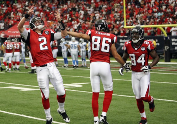 Matt Ryan acknowledges the crowd as he celebrates a touchdown pass to Michael Jenkins with teammates Brian Finneran and Roddy White.