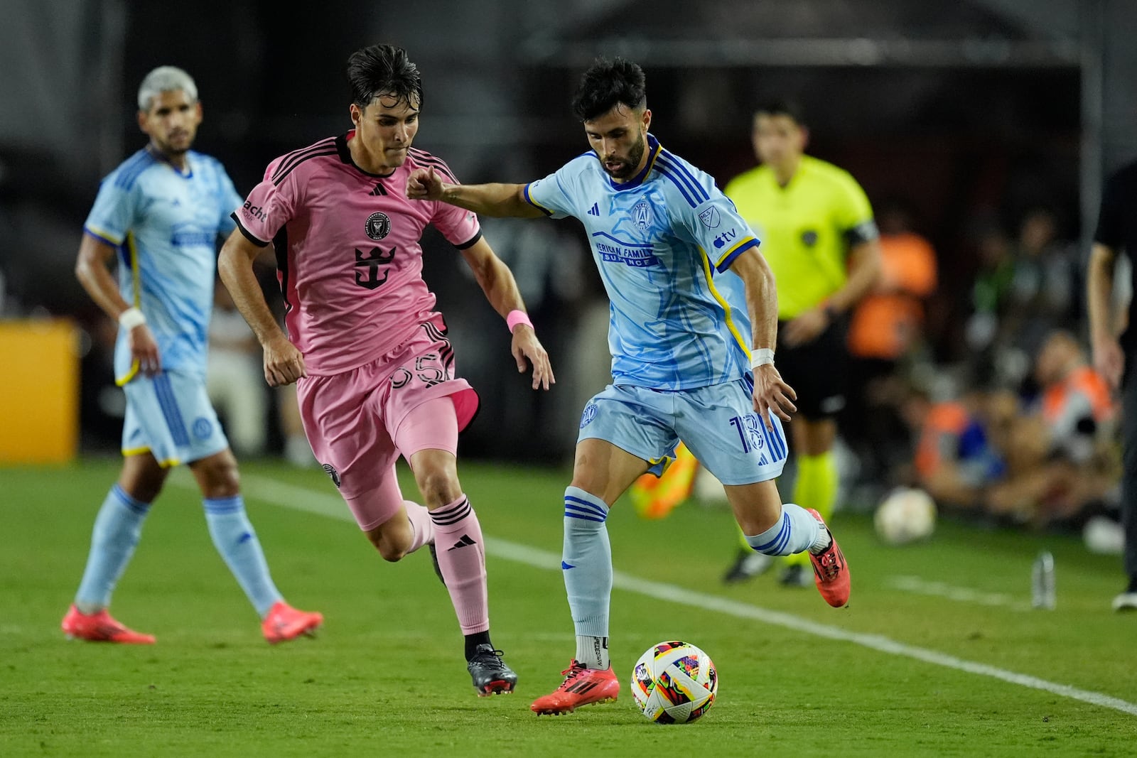 Atlanta United midfielder Dax McCarty (13) and Inter Miami midfielder Federico Redondo (55) go after the ball during the first half of an MLS playoff soccer match, Friday, Oct. 25, 2024, in Fort Lauderdale, Fla. (AP Photo/Rebecca Blackwell)