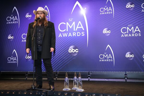 The gentlemanly Chris Stapleton and his newest additions to the CMA Awards trophy closet.  (Photo by Terry Wyatt/Getty Images)