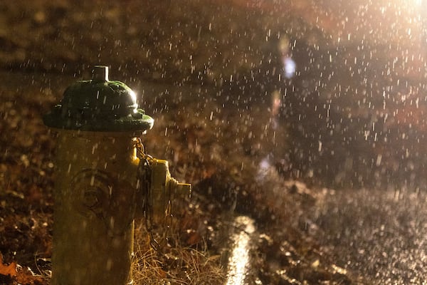 Headlights from a stranded motorist highlight freezing rain that coated surfaces in Omaha, Neb. on Friday, Dec. 13, 2024. (Chris Machian/Omaha World-Herald via AP)