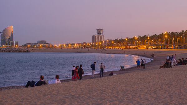 Lawyers ending their convention on Platja de la Barceloneta (the beach) at sundown. (Alan Behr/TNS)