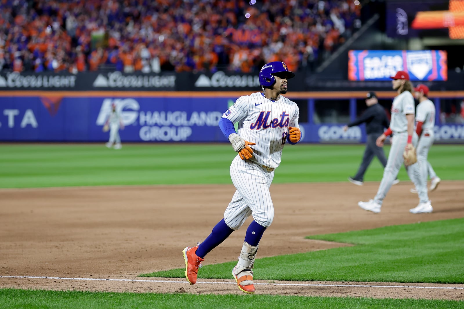 New York Mets shortstop Francisco Lindor (12) rounds the bases after hitting a grand slam home run against the Philadelphia Phillies during the sixth inning of Game 4 of the National League baseball playoff series, Wednesday, Oct. 9, 2024, in New York. (AP Photo/Adam Hunger)