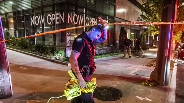 At least one window of the apartment building was shattered by what appeared to be a bullet hole. (John Spink / John.Spink@ajc.com)

