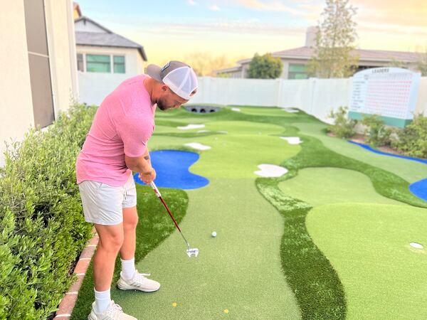 Andrew Augustyniak putts on his version of Augusta National Golf Club in his backyard in Gilbert, Arizona. (Sam Farmer/Los Angeles Times/TNS)