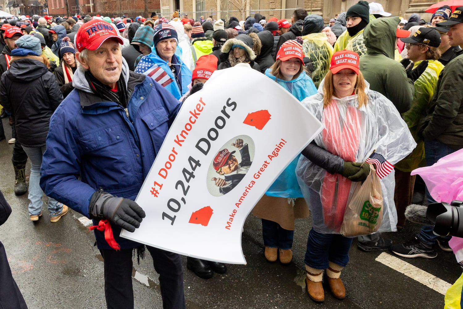 Kevin McCarthy of Canton holds a sign for a video camera while waiting to enter a Trump rally at Capital One Arena in Washington, D.C. on Sunday, January 19, 2025, one day before Donald Trump’s inauguration. (Arvin Temkar / AJC)