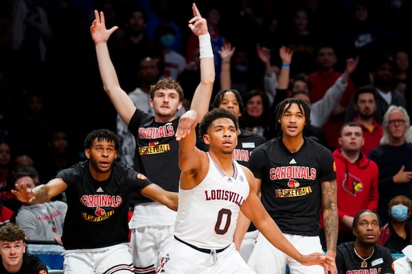 Louisville's Noah Locke (0) watches his three point shot during the second half of an NCAA college basketball game against Georgia Tech during the Atlantic Coast Conference men's tournament, Tuesday, March 8, 2022, in New York. (AP Photo/John Minchillo)