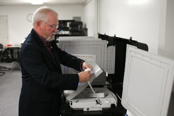 Merle King, executive director for The Center for Election Systems at Kennesaw State University, explains how a touchscreen machine voters works on Oct. 20. BRANDEN CAMP/SPECIAL