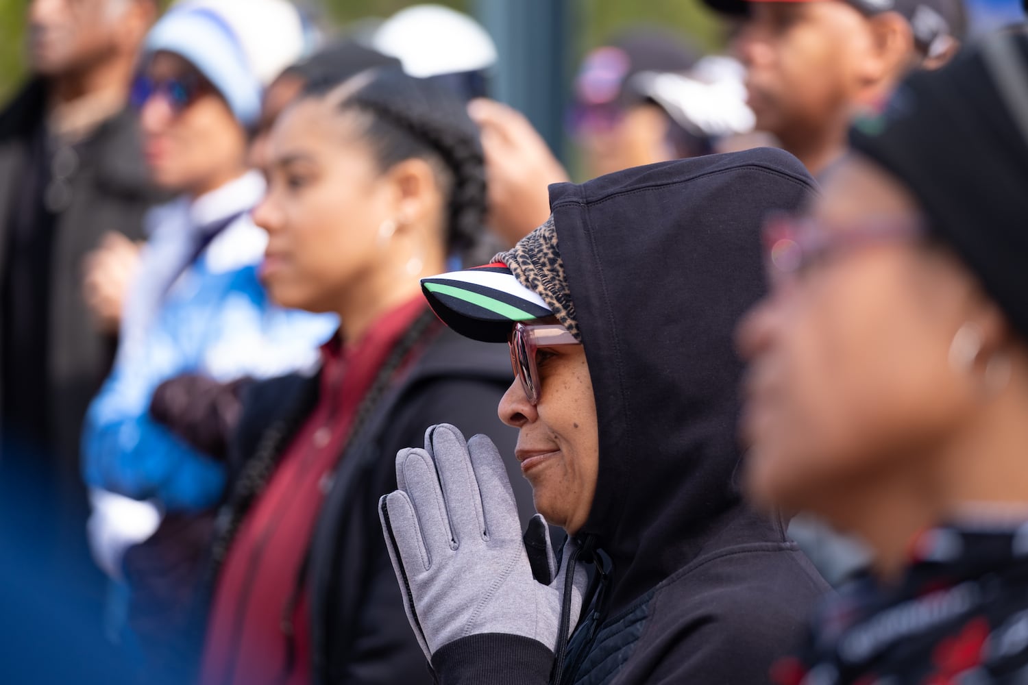 Kendall Watkins listens to speakers before the start of the 2.23 mile Ahmaud Arbery Day Run in Atlanta on Sunday, Feb. 23, 2025, to mark the anniversary of the day Arbery was killed while out on a run near Brunswick.   Ben Gray for the Atlanta Journal-Constitution