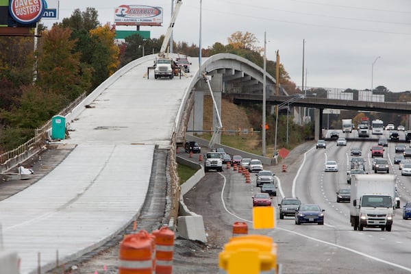 The Northwest Corridor Express Lanes, seen here under construction last year, rise and fall beside the regular lanes on I-75 in Cobb County. A Conyers man has nicknamed the toll lanes the “Tollercoaster,” and hopes the name will stick. PHIL SKINNER/AJC