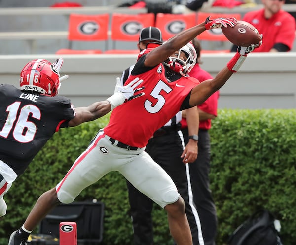 Georgia wide receiver Adonai Mitchell catches a touchdown pass past defensive back Lewis Cine during the final drive of the second quarter in the  G-Day Game at Sanford Stadium on Saturday, April 17, 2021, in Athens.   “Curtis Compton / Curtis.Compton@ajc.com”