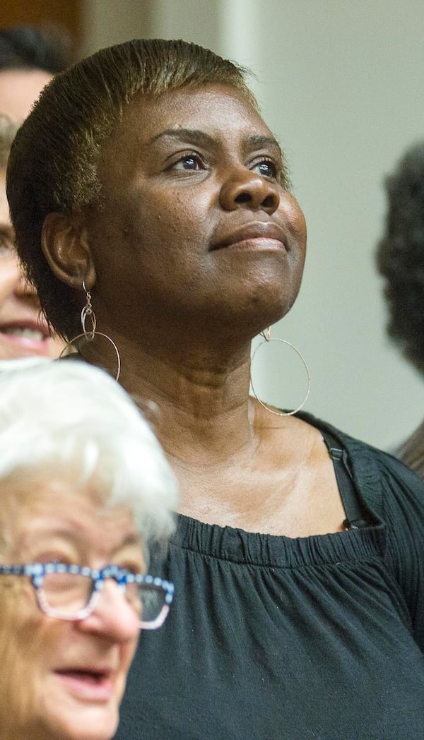 04/12/2019  -- Atlanta, Georgia -- Violet Clark, a graduate of the Grady Chronic Care Clinic, smiles while taking a group photo following a graduation celebration at Grady Memorial Hospital in Atlanta, Friday, April 12, 2019. The Chronic Care Clinic hosted a celebration graduation for people who had fallen out of the health system, except for going to the ER for emergencies. These patients are signed up for the Chronic Care Clinic and "surrounded" with resources including a community health worker who works with them to educate them on using resources properly, such as taking medications regularly, going to a primary care clinic for non-emergencies, and keeping up with problems before they become emergencies. (ALYSSA POINTER/ALYSSA.POINTER@AJC.COM)