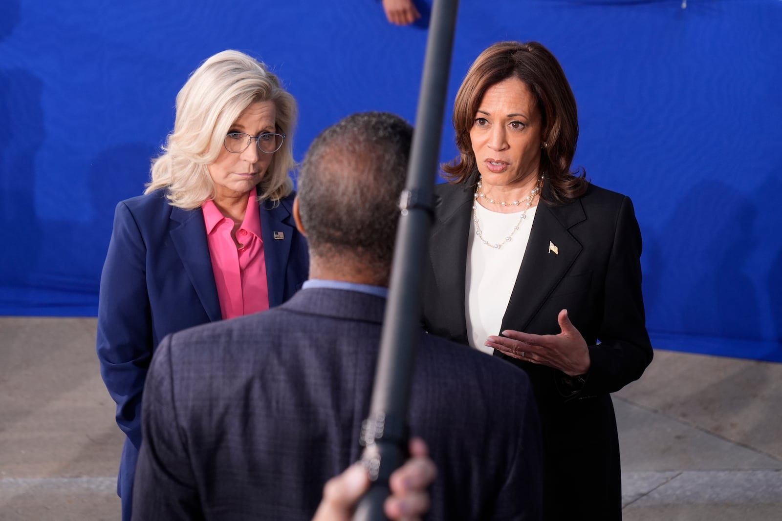 Democratic presidential nominee Vice President Kamala Harris, right, and former Congresswoman Liz Cheney, R-Wyo., speak to a reporter during a campaign event at Ripon College in Ripon, Wis., Thursday, Oct. 3, 2024. (AP Photo/Mark Schiefelbein)