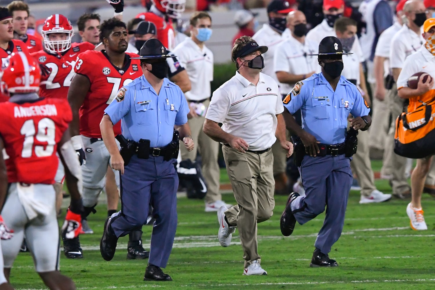 Georgia head coach Kirby Smart is flanked by  state troopers as he comes on the field after a football game against Tennessee on Saturday, Oct. 10, 2020, at Sanford Stadium in Athens. Georgia won 44-21. JOHN AMIS FOR THE ATLANTA JOURNAL- CONSTITUTION