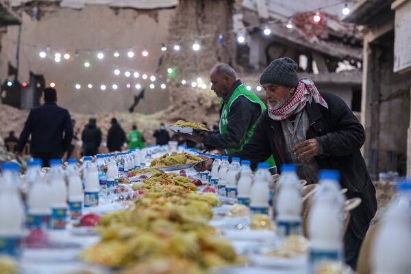 A table is prepared for iftar, the fast-breaking meal, organized by the Turkish Humanitarian Relief Foundation (IHH), on the first day of Ramadan in the Jobar neighborhood, which was devastated by the Syrian war, in Damascus, Syria, on Saturday, March 1, 2025.(AP Photo/Ghaith Alsayed)