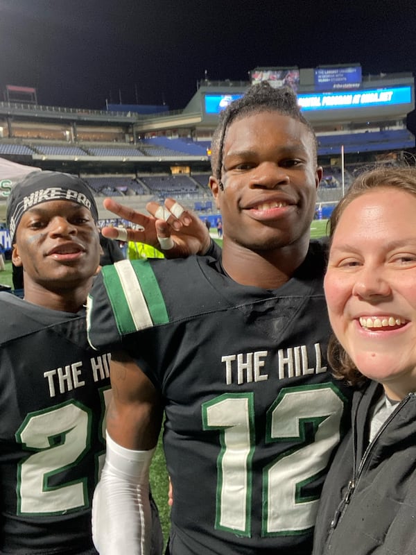 Former Collins Hill High standout Travis Hunter (center) poses for a photo with Collins Hill assistant principal Heather Childs and teammate Chase Nash following the Eagles' Class 7A state championship win over Milton at Georgia State's Center Parc Stadium Dec. 11, 2021. It was the school's first-ever football state title. (Photo courtesy Heather Childs)