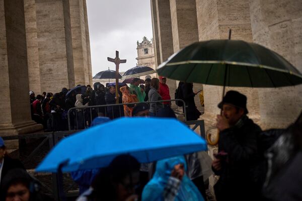 Catholic worshippers arrive to St. Peter's Square on a rainy day at the Vatican, Wednesday, March 12, 2025. (AP Photo/Francisco Seco)